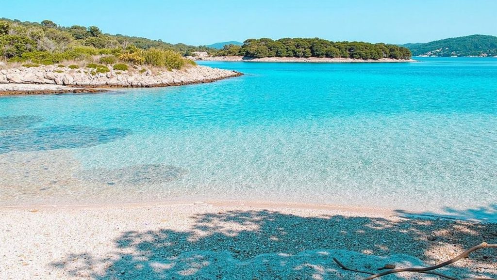 Detalle de arena y agua en Ždrilca, Croacia